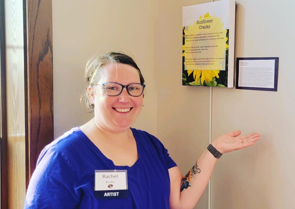 Rachel next to her poem at the 2023 Gilda's Club Madison Art Show.